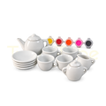 White ceramic tea set with cups, saucers, teapot and colourful paints